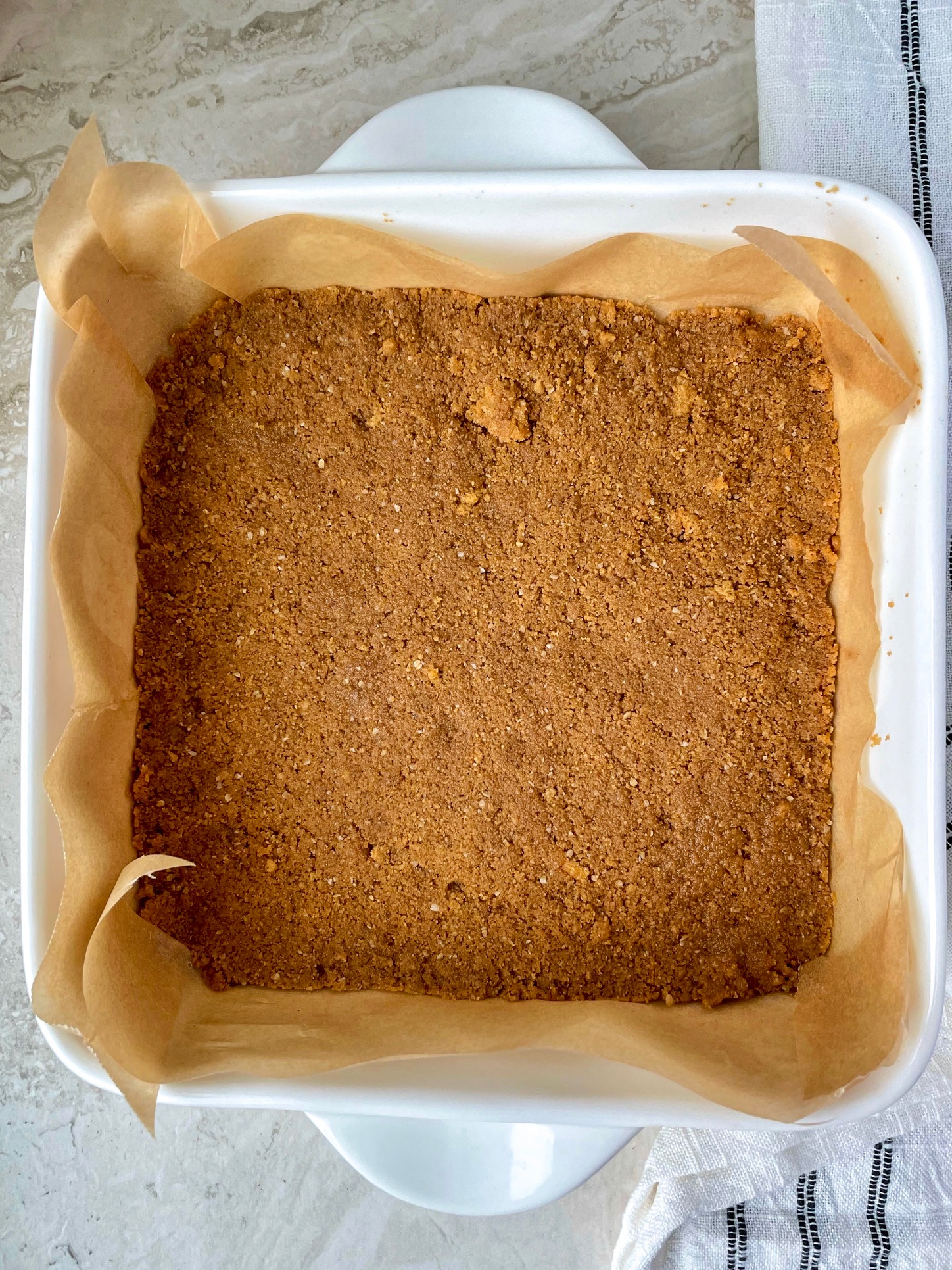 the gluten free graham cracker crust in the pan before baking