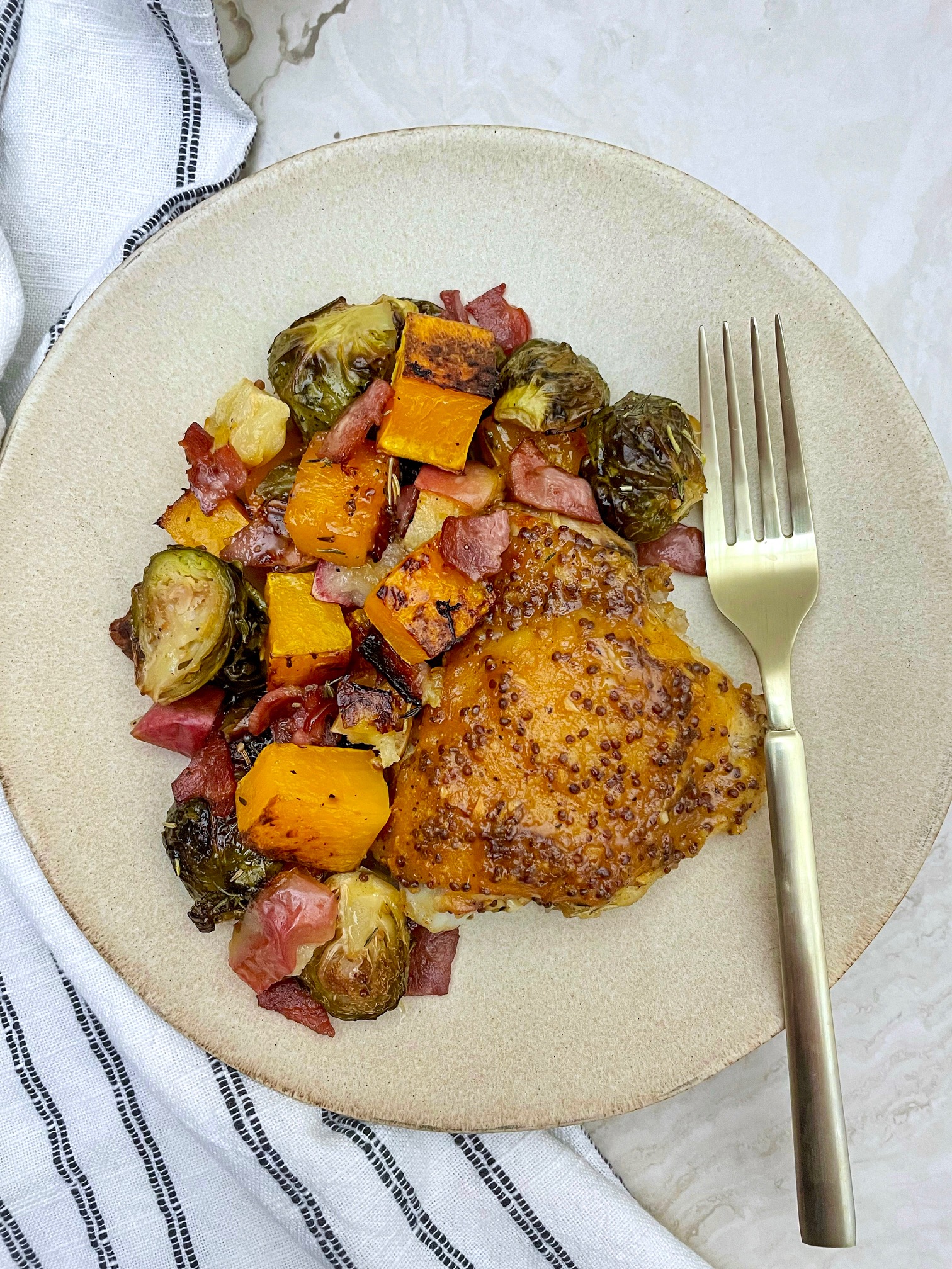 a plate with maple mustard chicken and roasted veggies