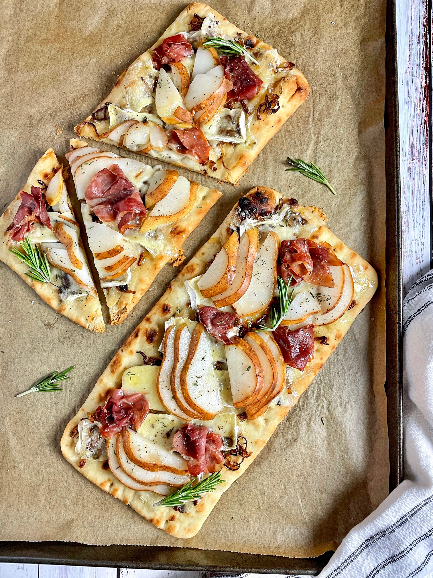 pear and brie flatbreads on a baking sheet after baking