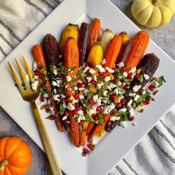 the finished honey roasted carrots with goat cheese on a serving platter