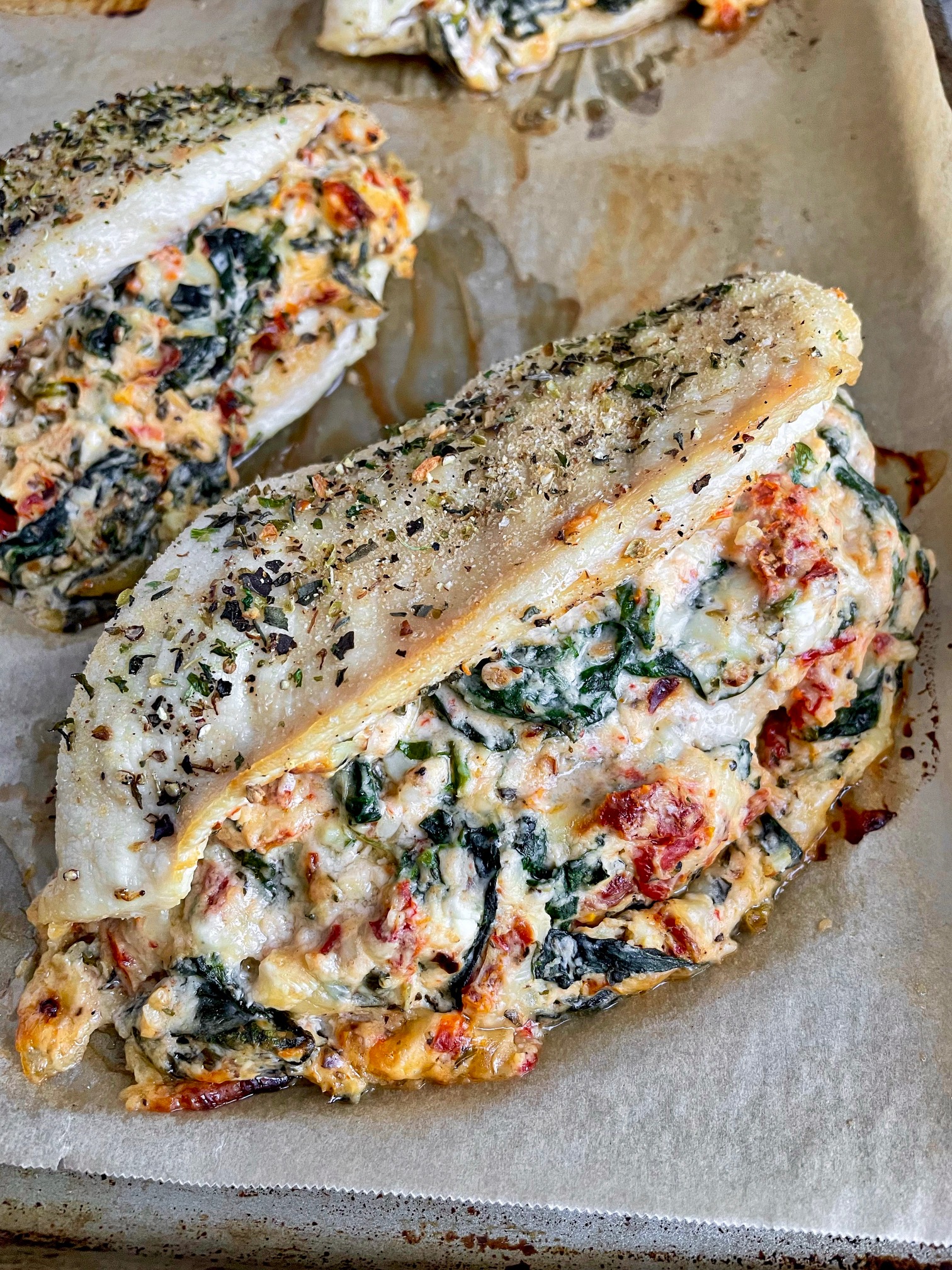 a close up of a tuscan stuffed chicken breast to see the detail in the stuffing