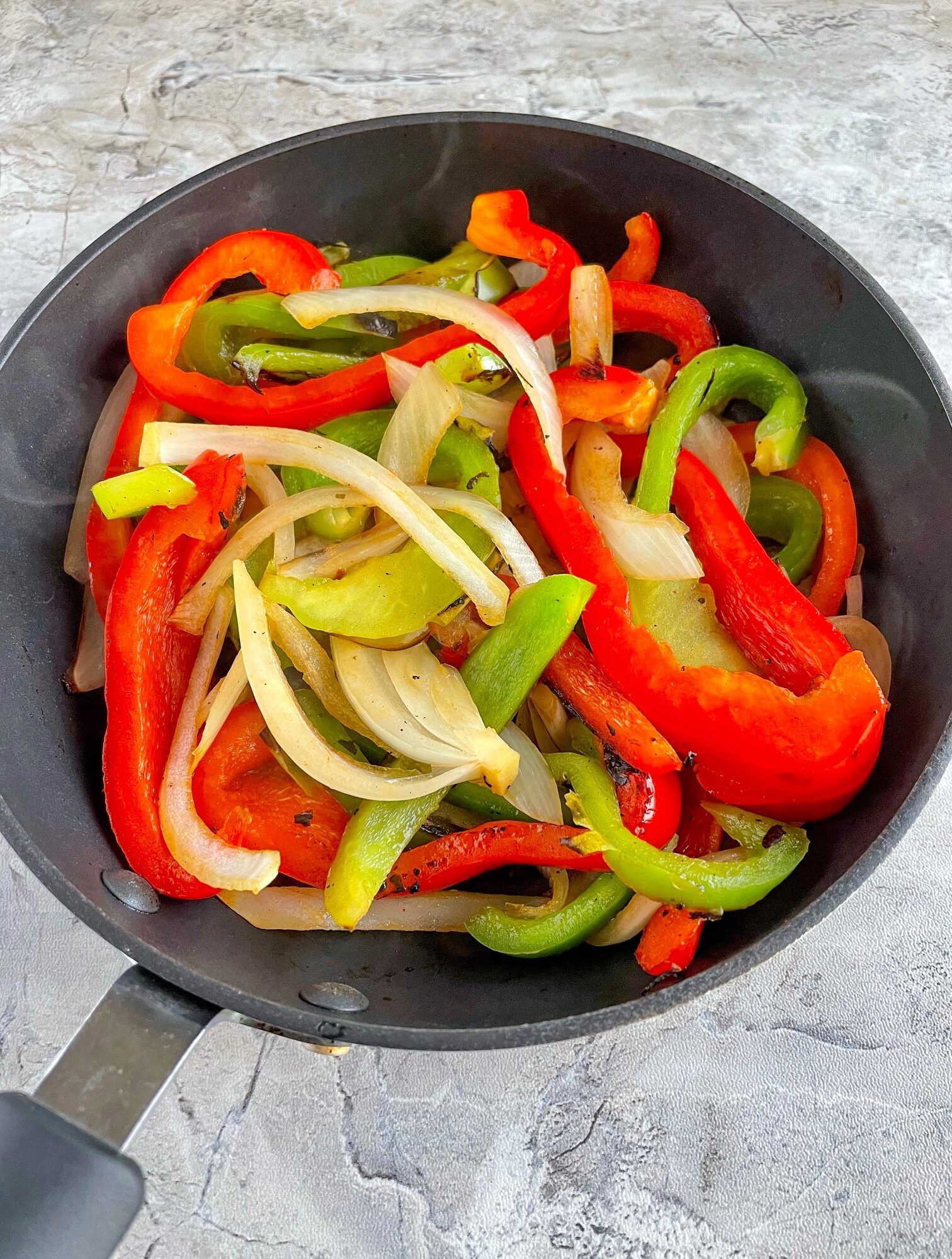 sauteed peppers and onions in the frying pan