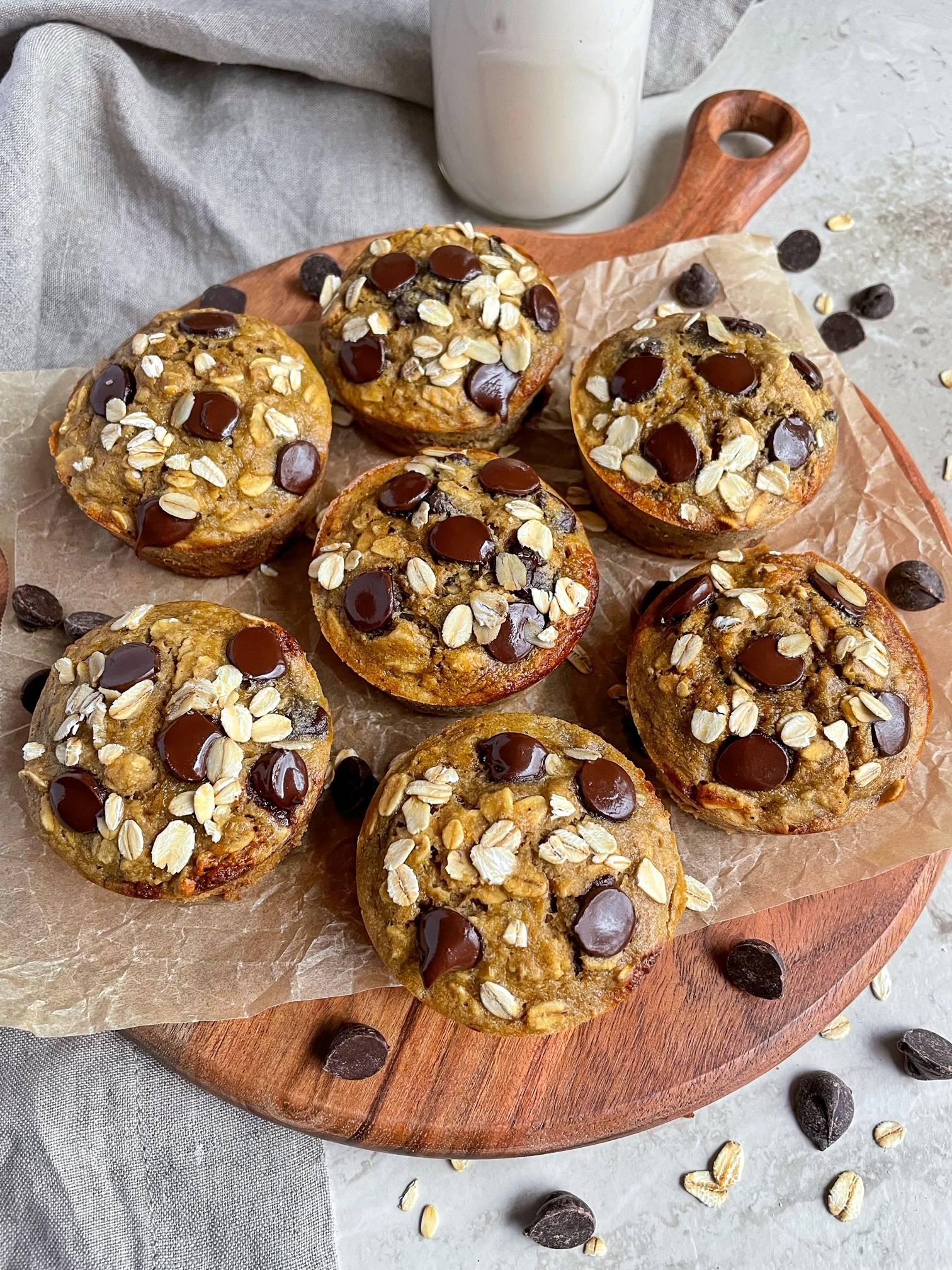 oat flour banana chocolate chip muffins on a wooden board