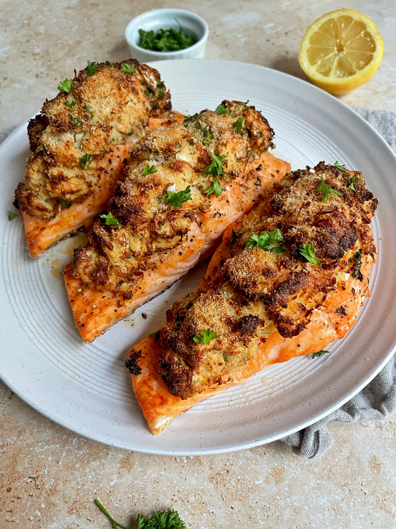 three pieces of air fried crab stuffed salmon on a plate.