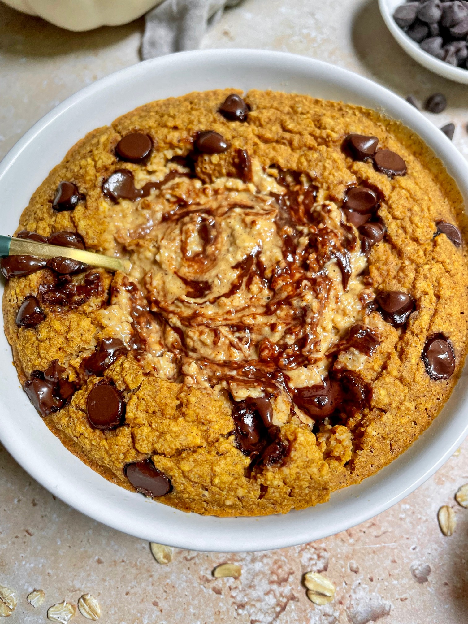 pumpkin blended baked oats with a spoon in the center.
