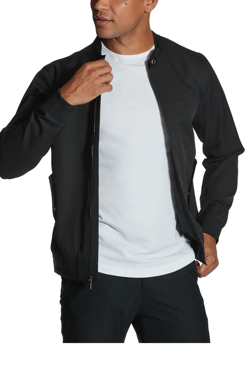 A man wearing a black bomber jacket.