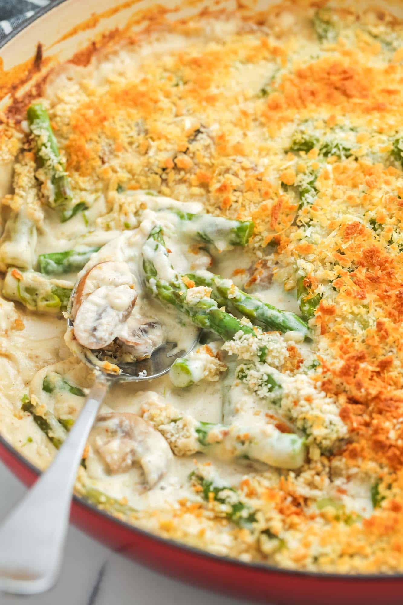 a close up shot of asparagus casserole with scoop taken out.