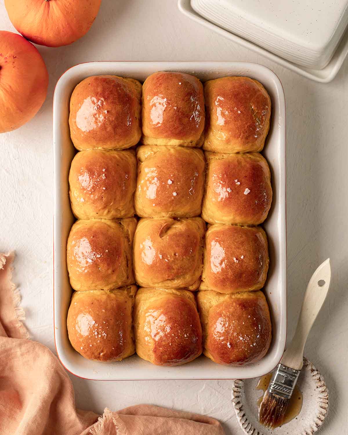 a bakind dish of vegan pumpkin dinner rolls