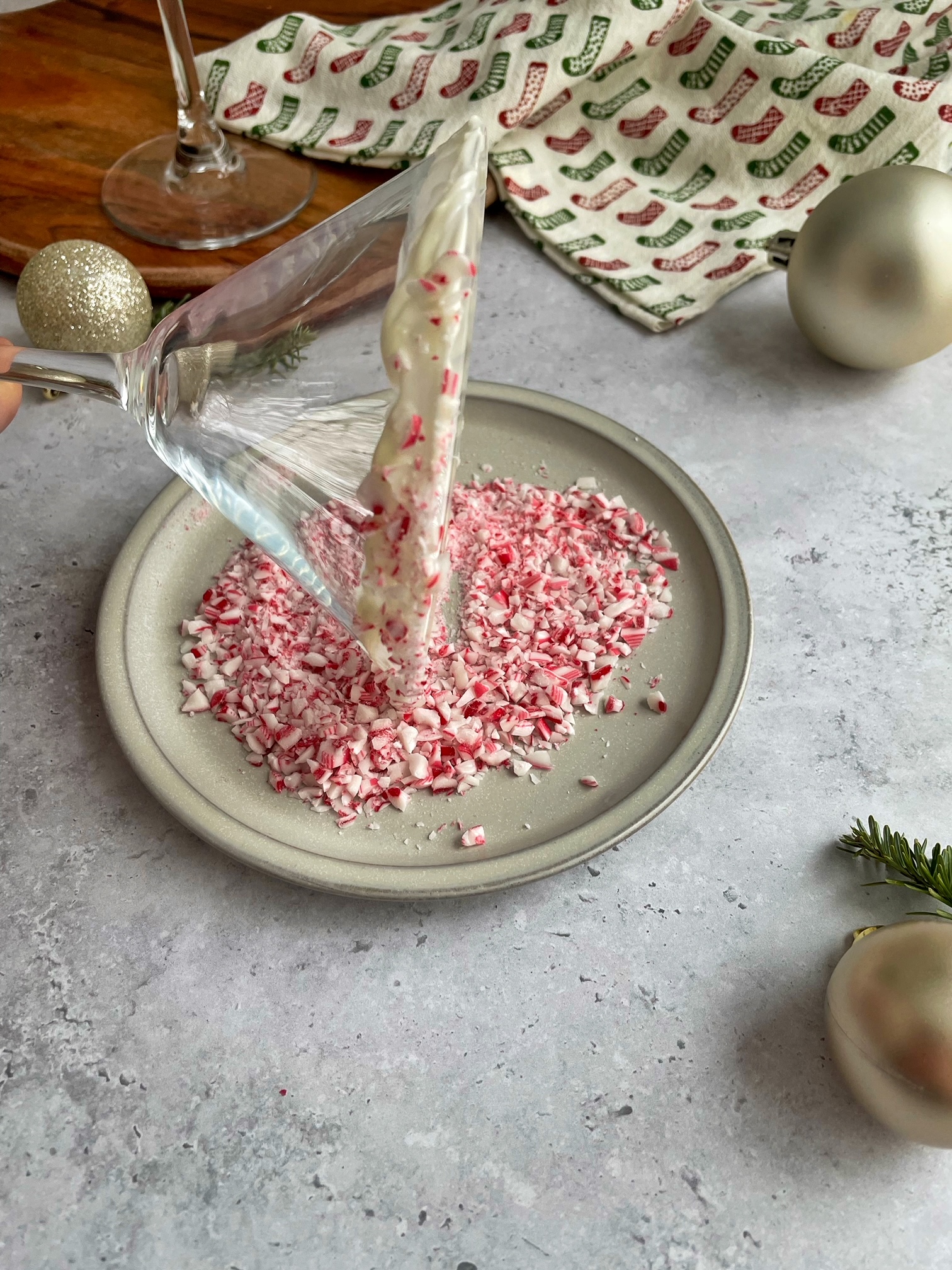 dipping the white chocolate coated rim in crushed candy canes.