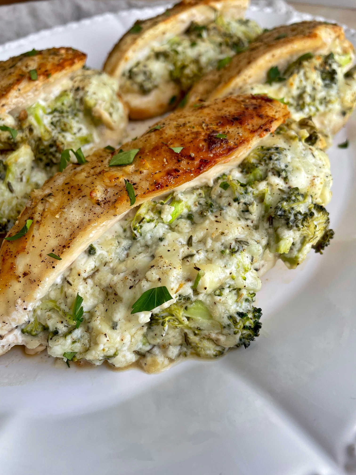 A close up of broccoli and cheese stuffed chicken breasts to show detail.