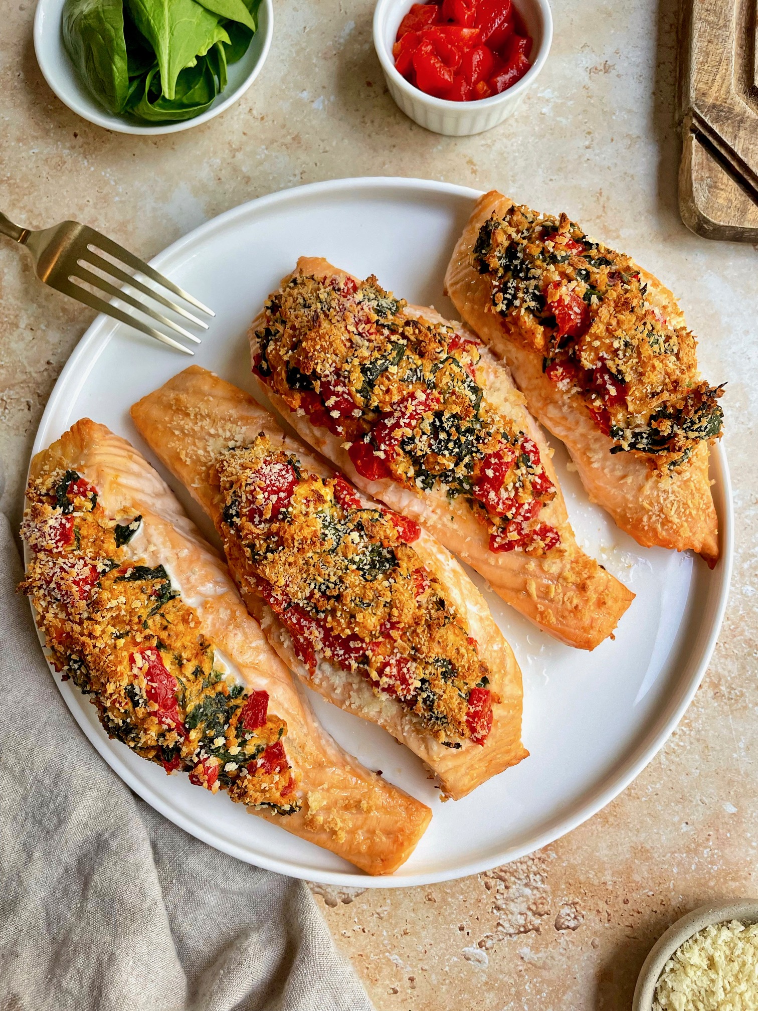 red pepper and spinach stuffed salmon on a plate.