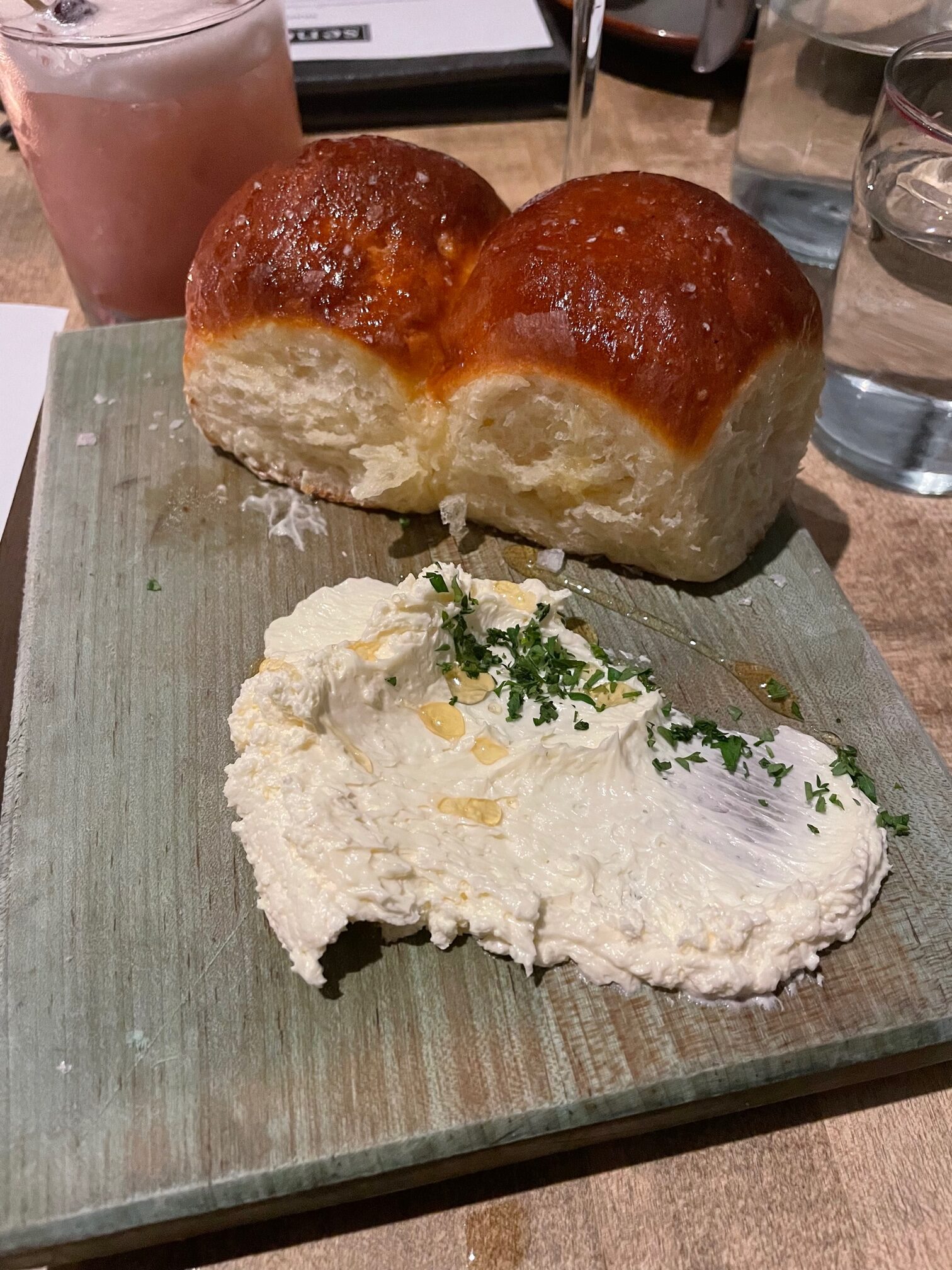 Parker house rolls and butter on a bard from Seneca restaurant in Saratoga Springs NY.