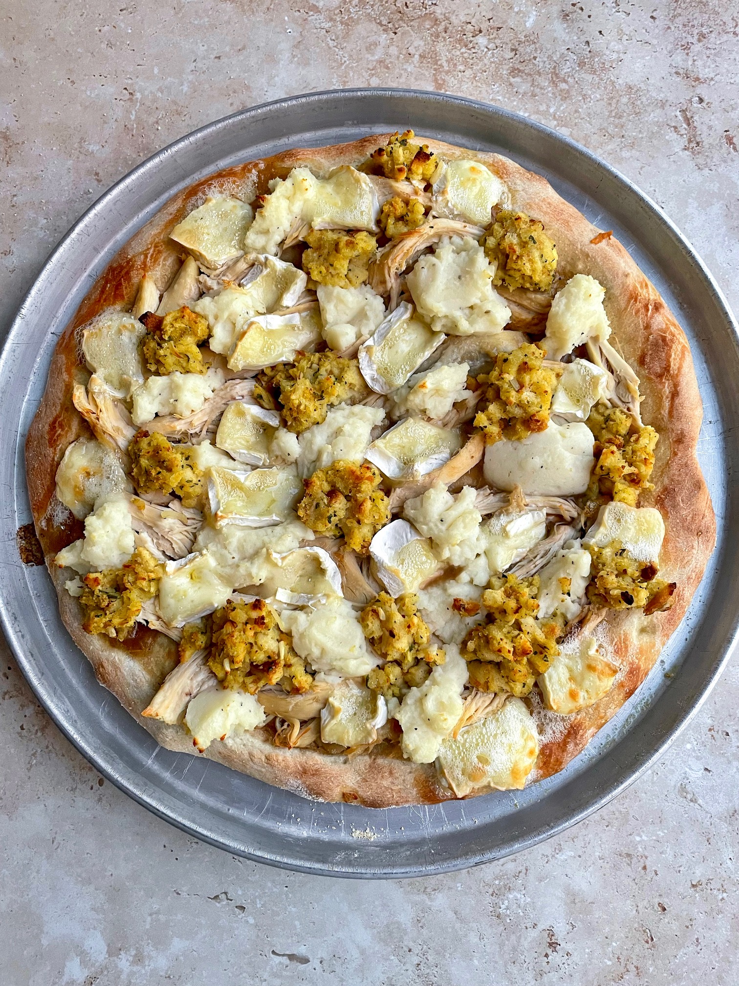 The pizza before being topped with cranberry sauce and crispy sage.