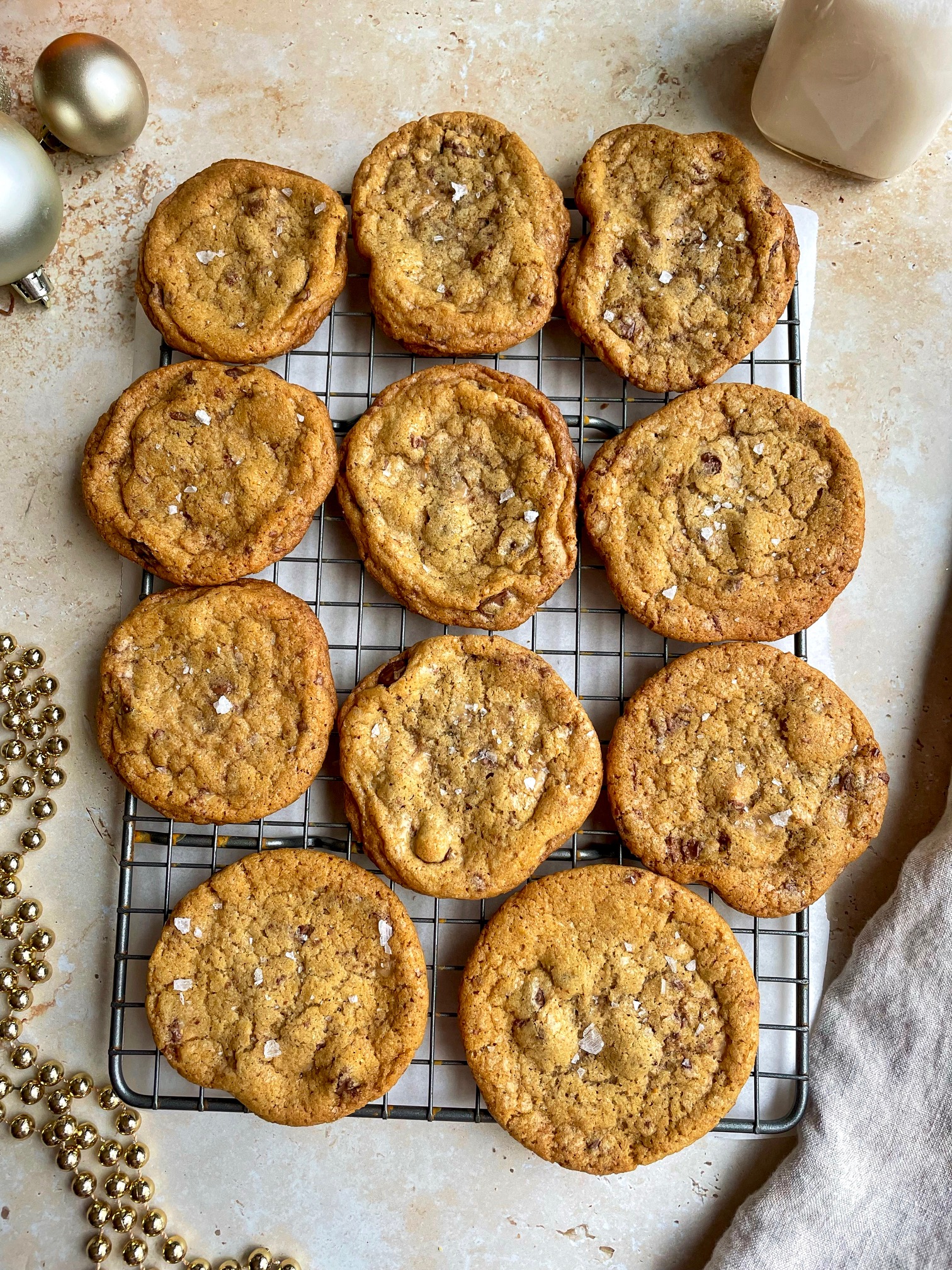 Brown butter toffee chip cookies on a cooling rack.