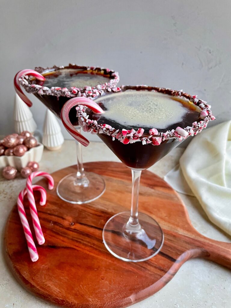 Peppermint espresso martinis with a candy cane rim and a small candy cane garnish.