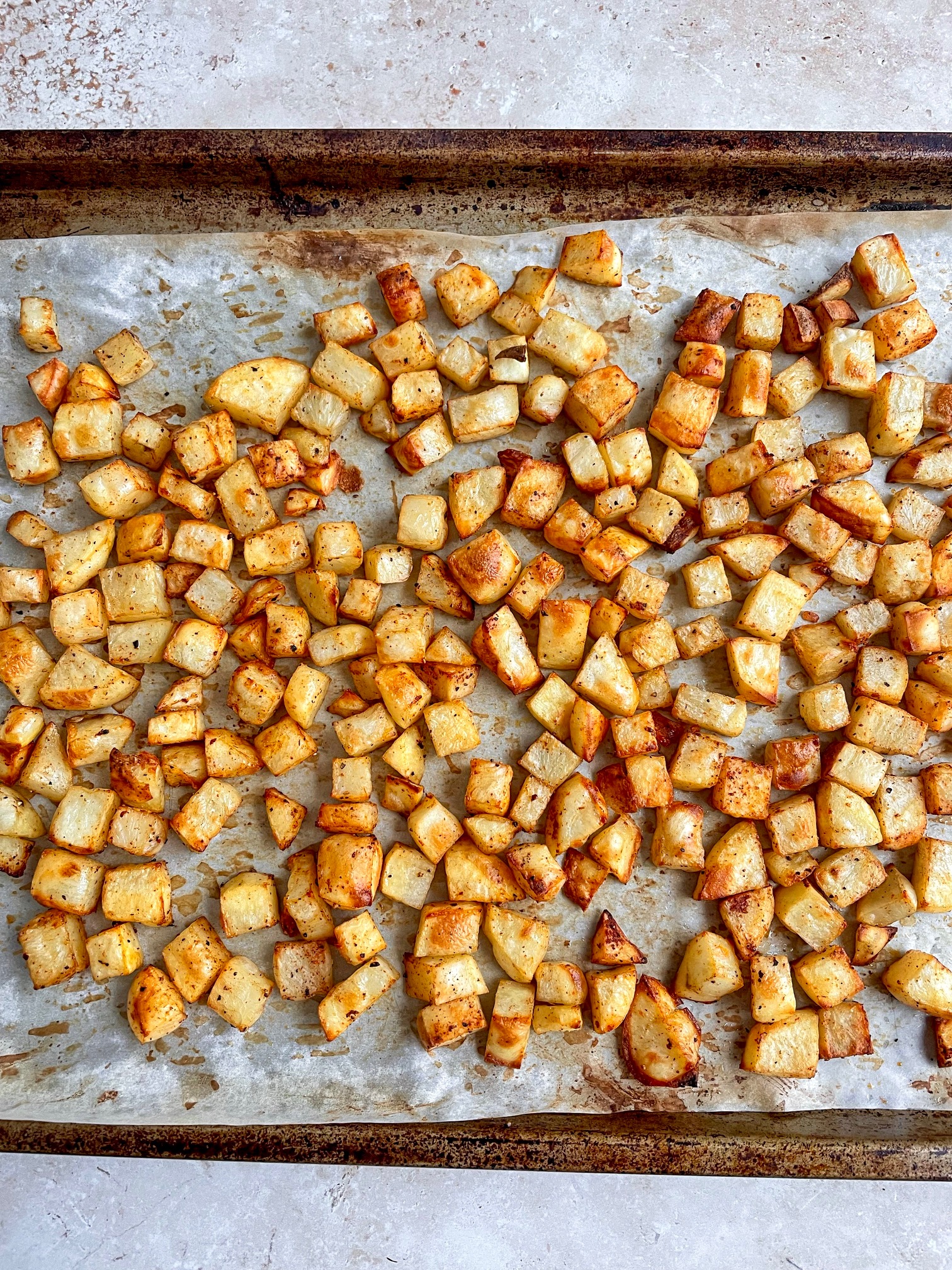 a baking sheet with roasted potatoes.