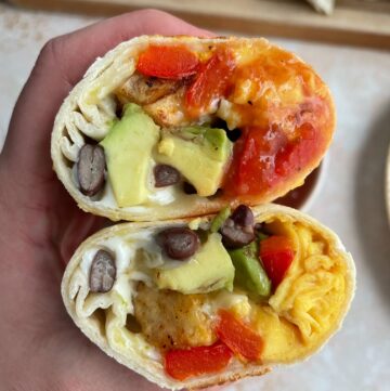 the cross section of the breakfast burrito with potatoes.