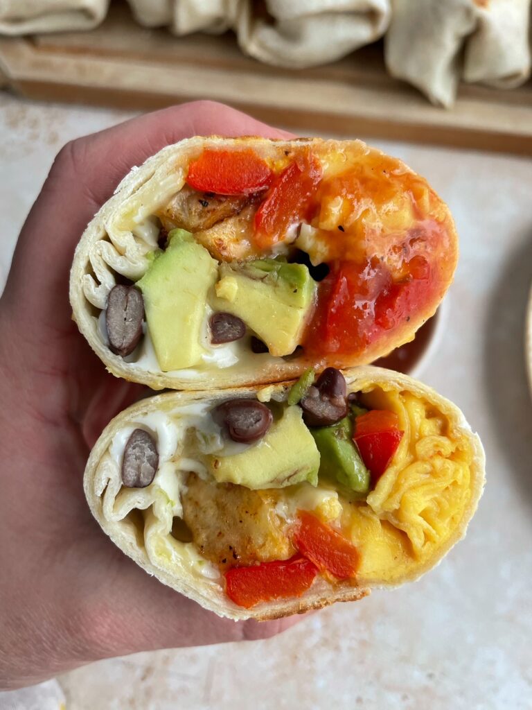 the cross section of the breakfast burrito with potatoes.