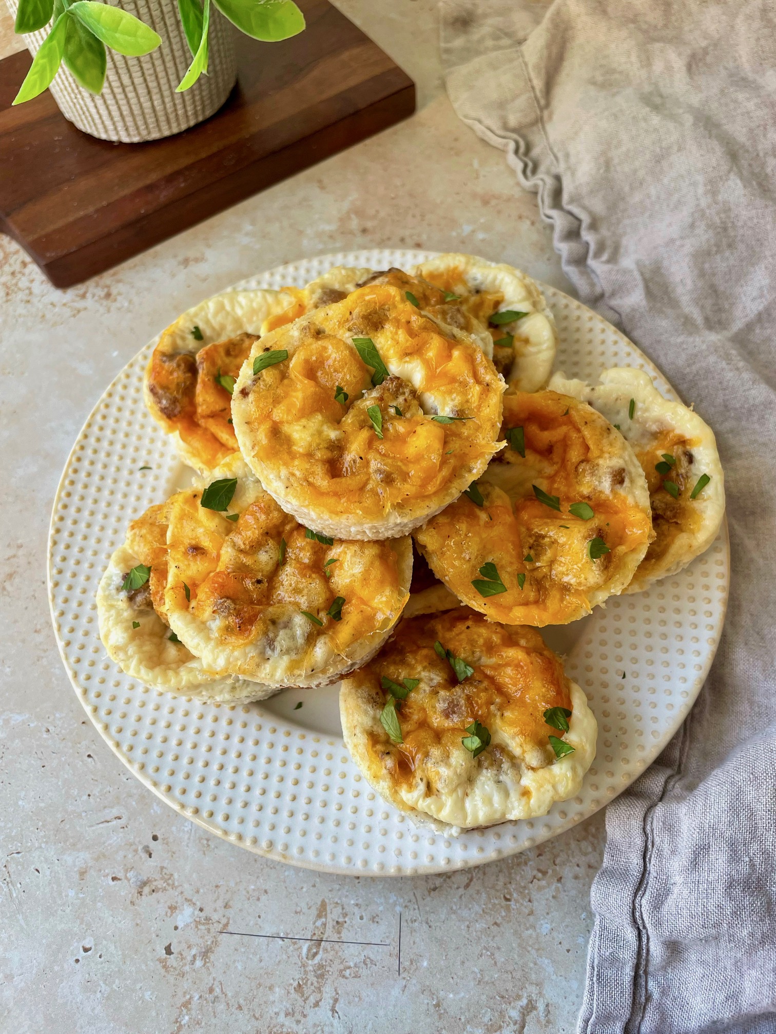 A plate stacked high with sausage and cheddar egg white bites.