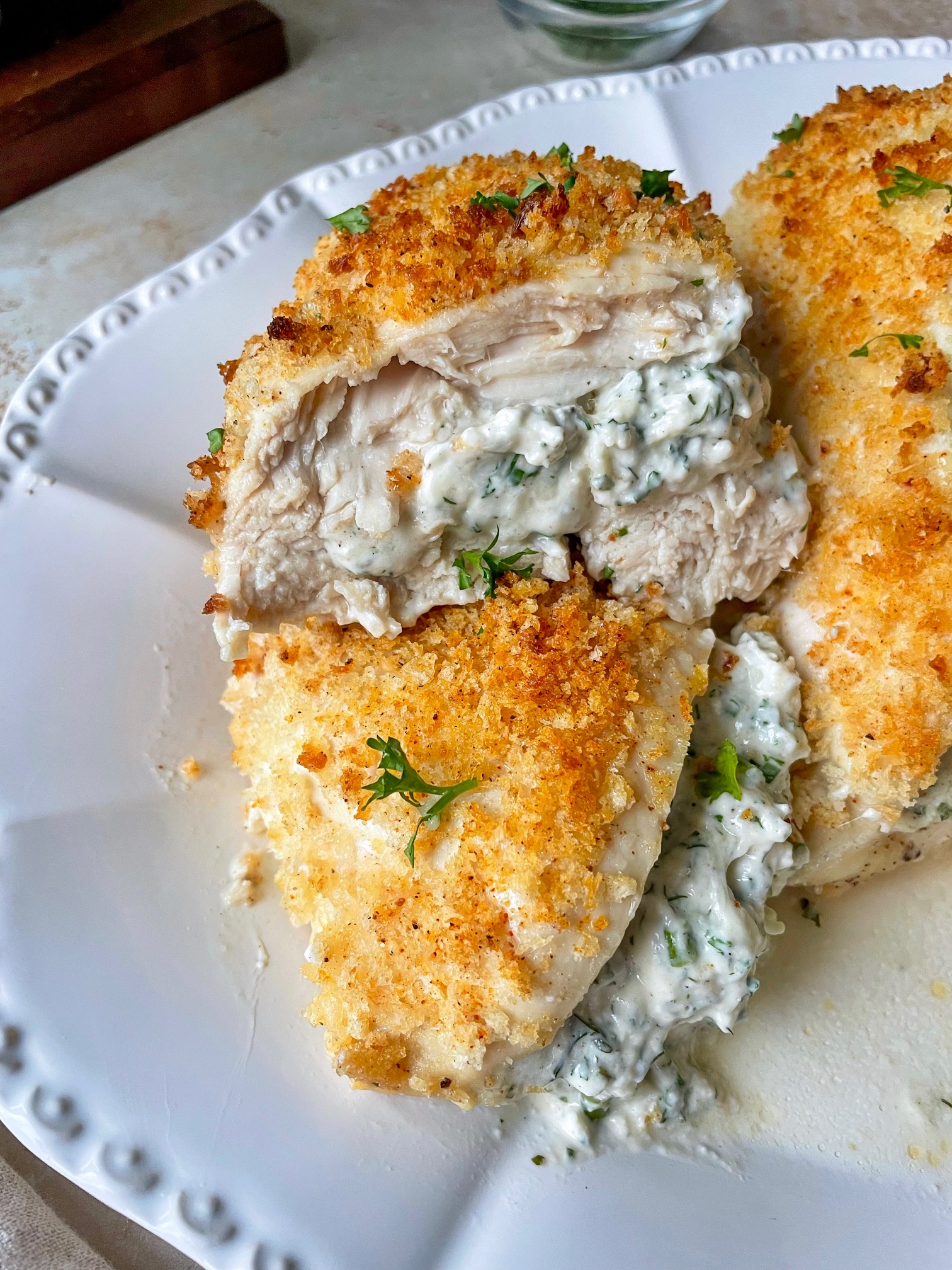 A stuffed chicken breast cut in half to show the filling.