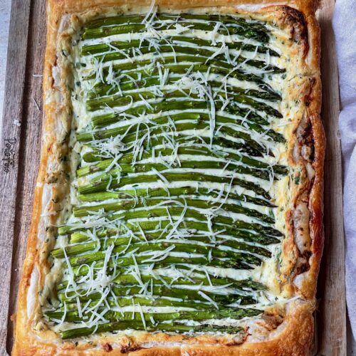 An overhead shot of the asparagus tart on a cutting board.