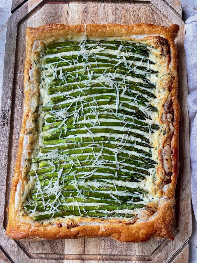 An overhead shot of the asparagus tart on a cutting board.