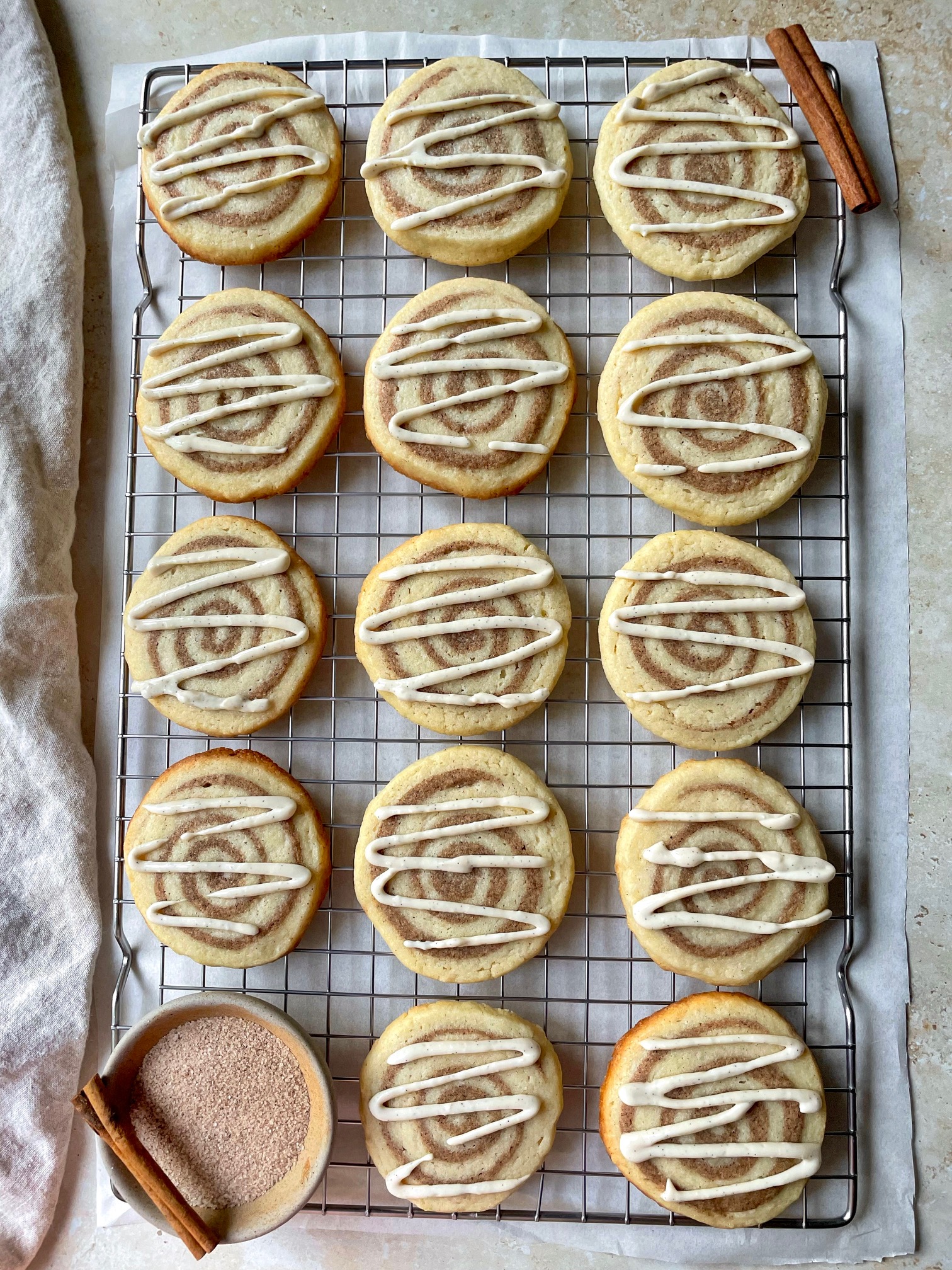 An overhead shot of cinnamon roll sugar cookies on a wire cooling rack.
