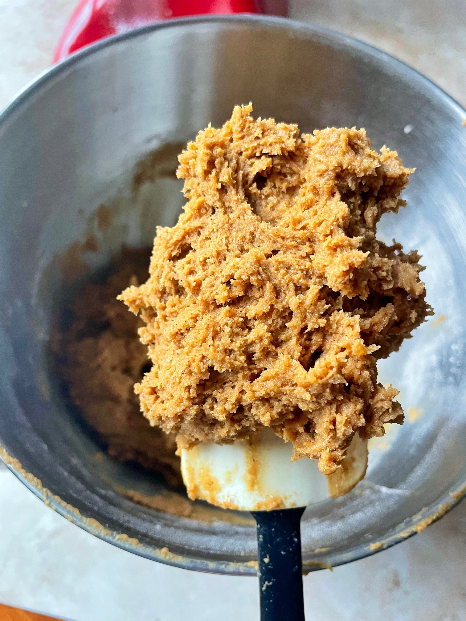 A close up of a scoop of the cookie dough on a rubber spatula.