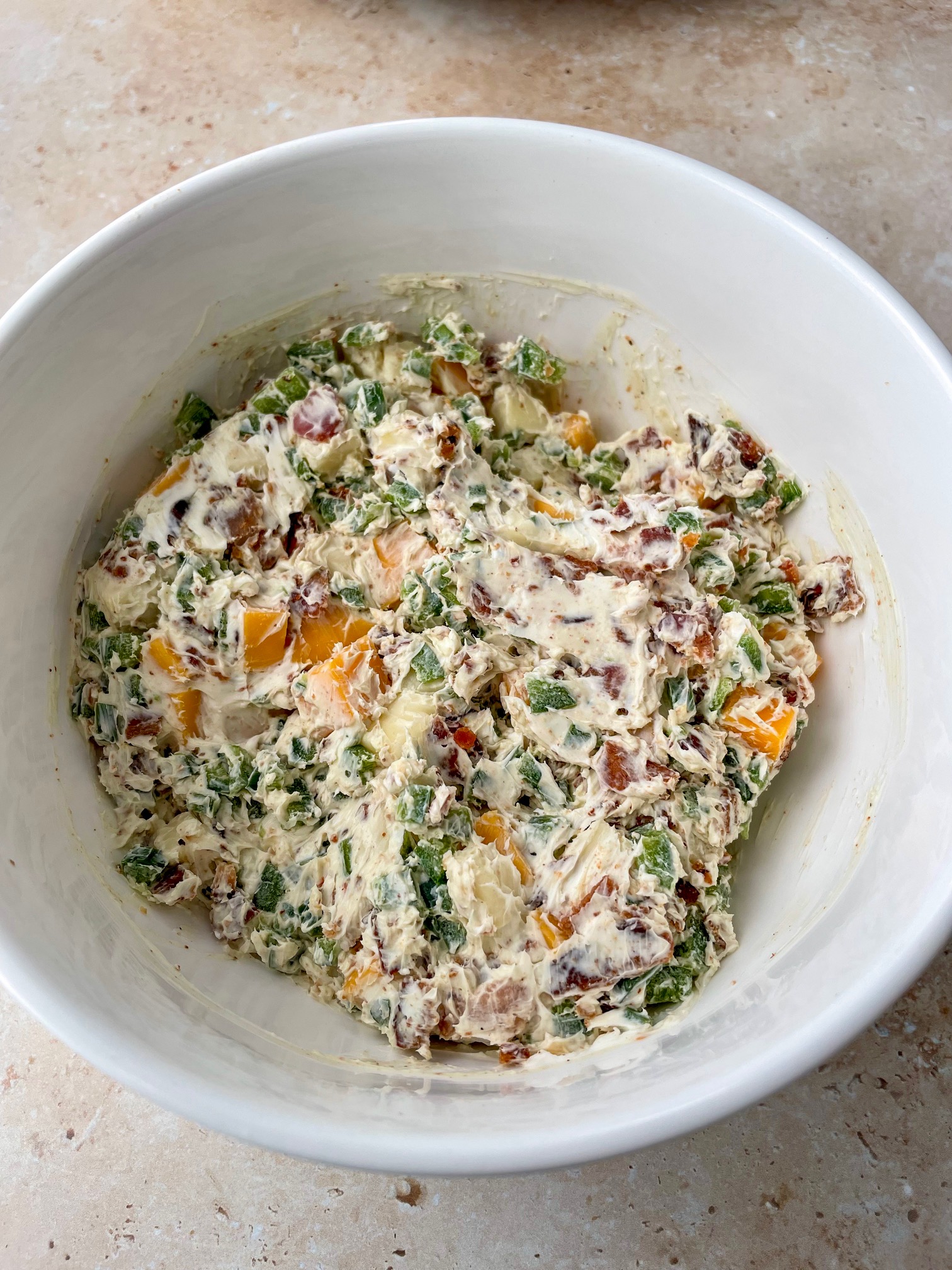 A close up of the jalapeƱo popper filling to show texture, color and ingredients.