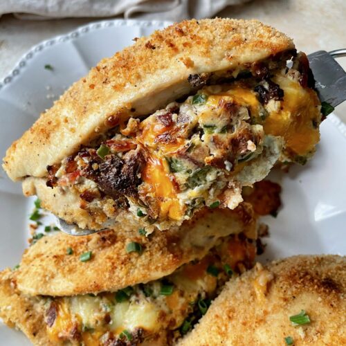 A close up of a jalapeƱo popper stuffed chicken breast on a spatula.