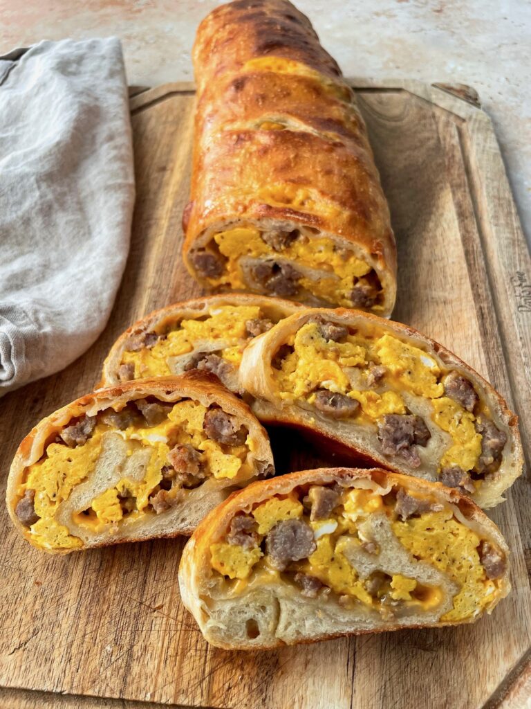 Slices of breakfast garbage bread displayed on a cutting board.
