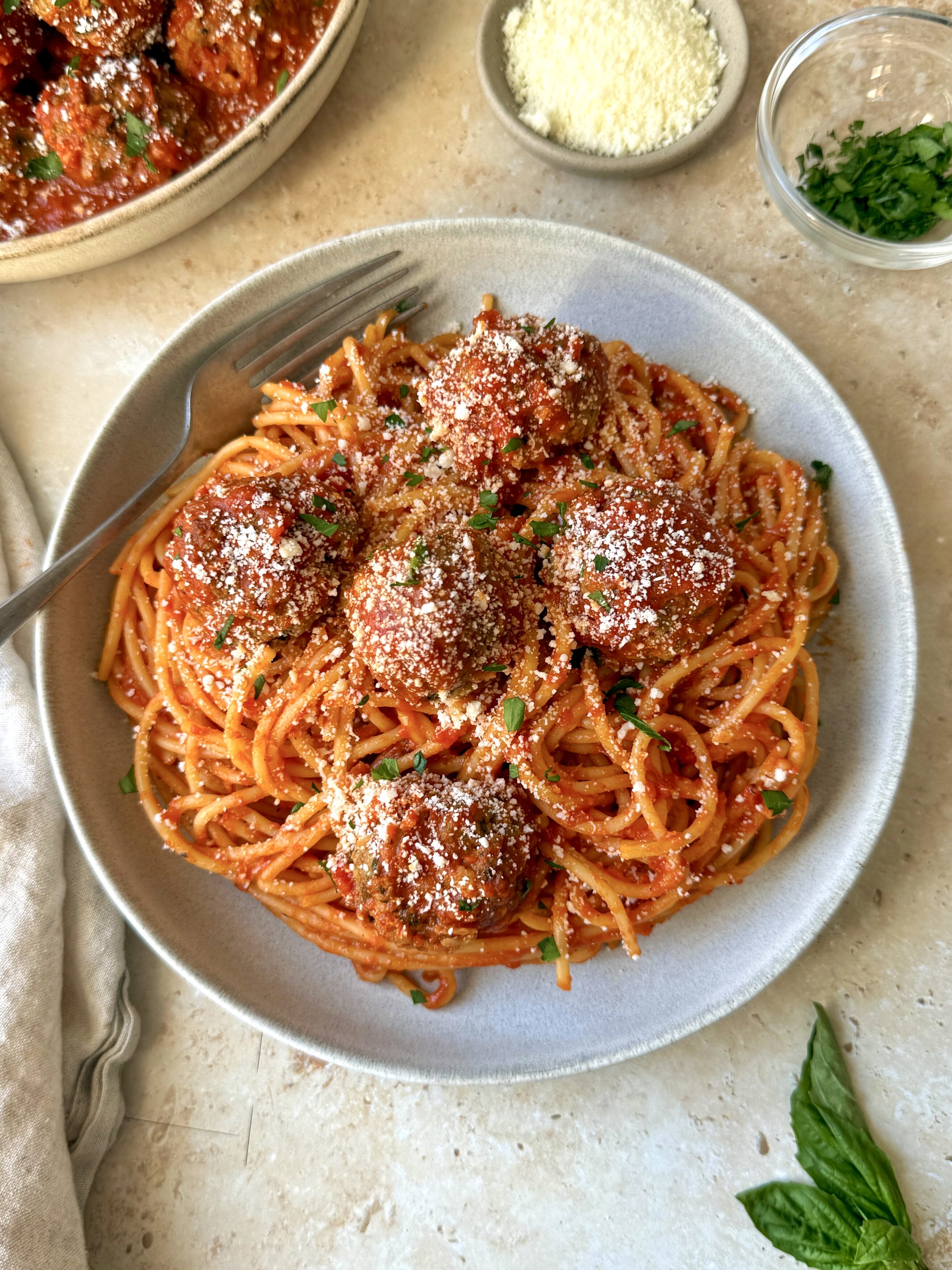 An overhead shot of the meatballs on a bed of spaghetti to show a serving suggestion.