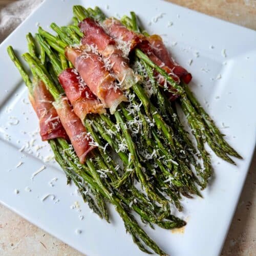 Prosciutto Wrapped asparagus on a serving platter.
