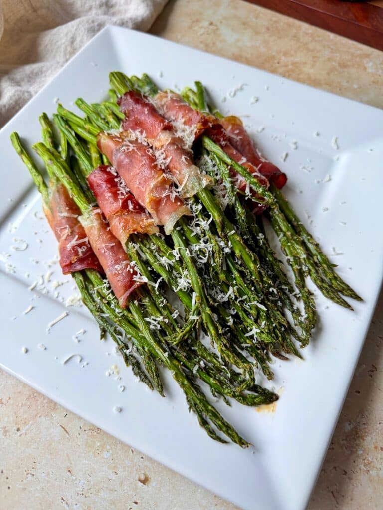 Prosciutto Wrapped asparagus on a serving platter.