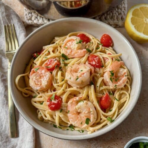 A bowl of creamy lemon garlic shrimp pasta.