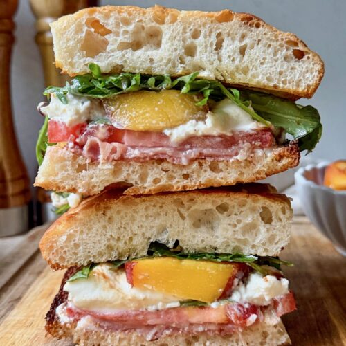 Peach, prosciutto and burrata sandwich cross section.