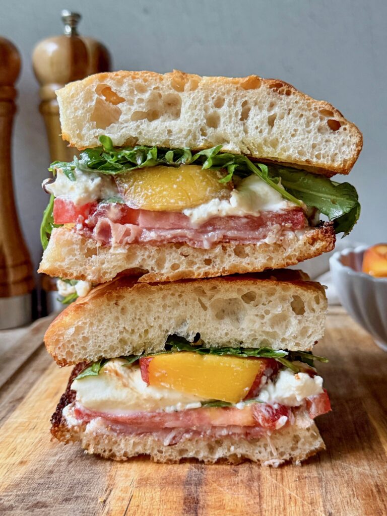 Peach, prosciutto and burrata sandwich cross section.