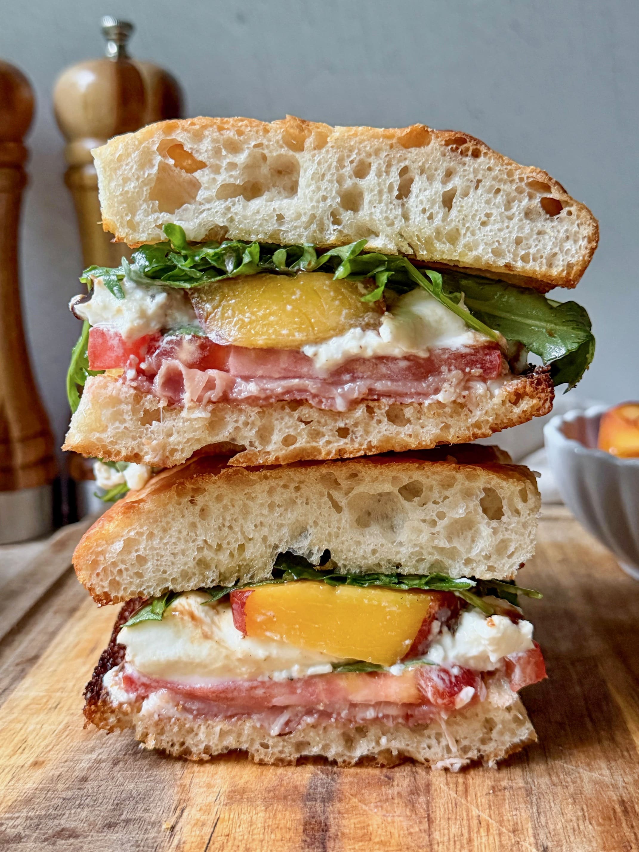 Peach, prosciutto and burrata sandwich cross section.