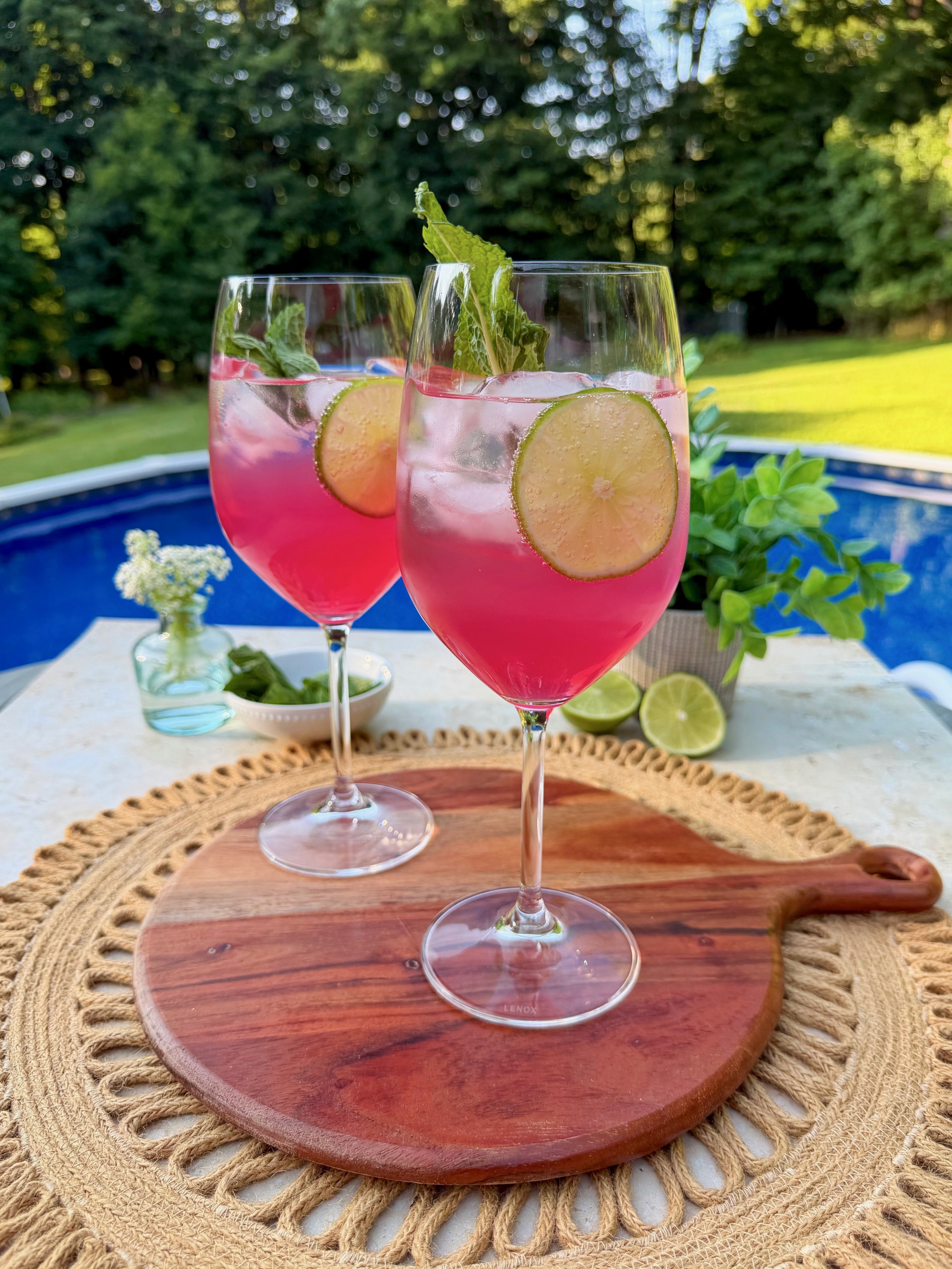 Two sarti spritz in wine glasses outside.