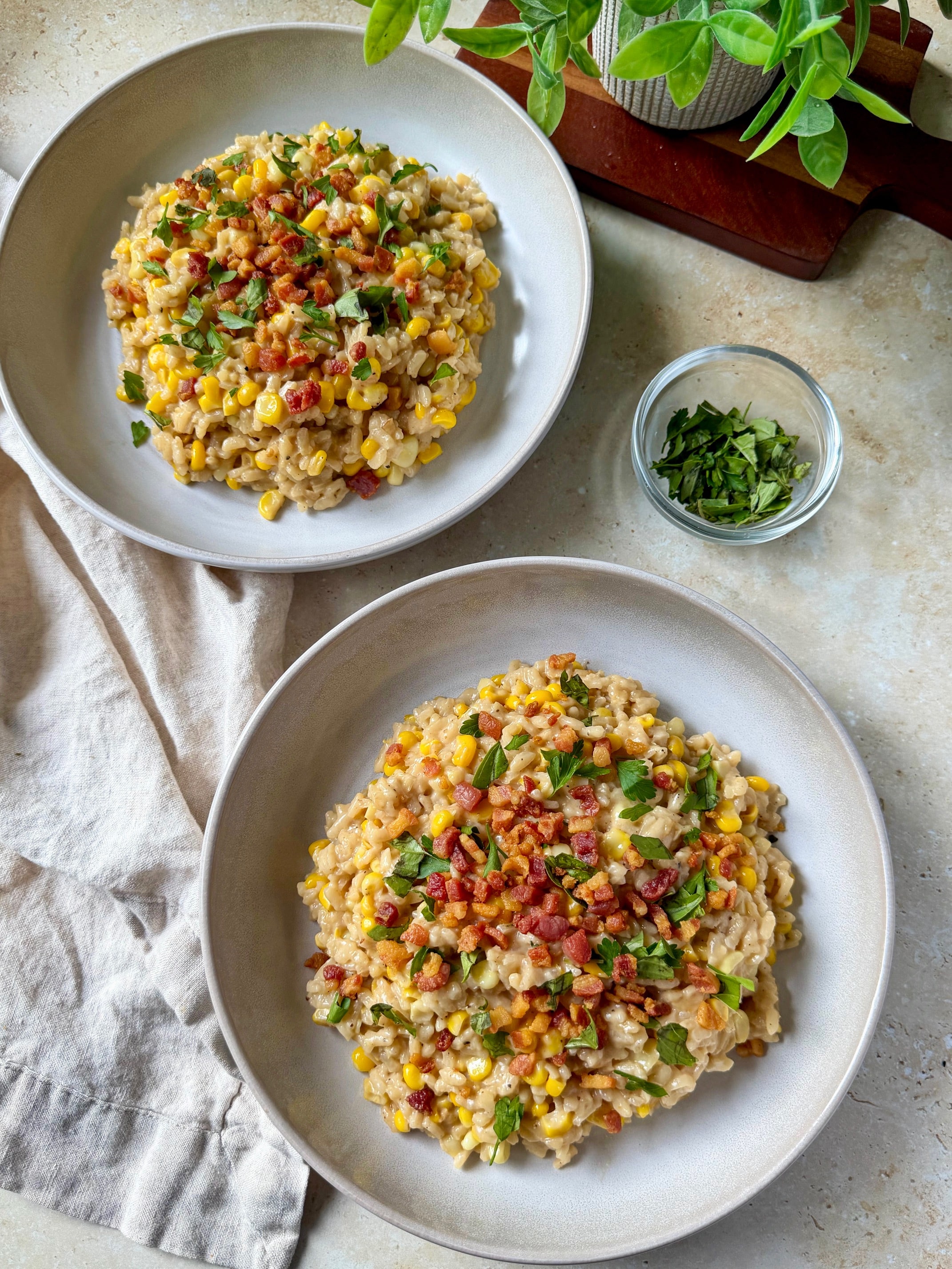 An overhead shot of two bowls of sweet corn mascarpone risotto.