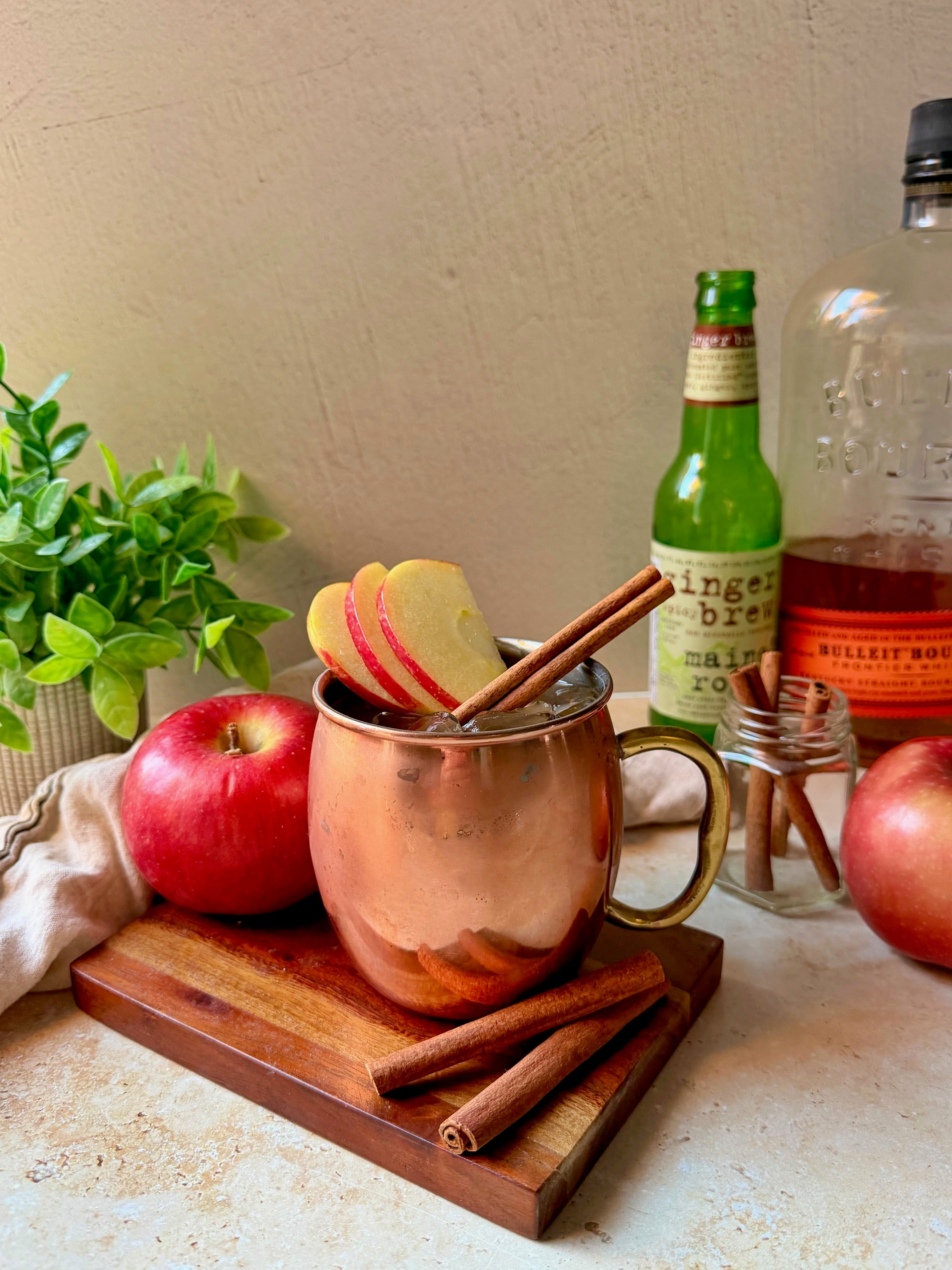 Apple cider bourbon mule in a mule glass.