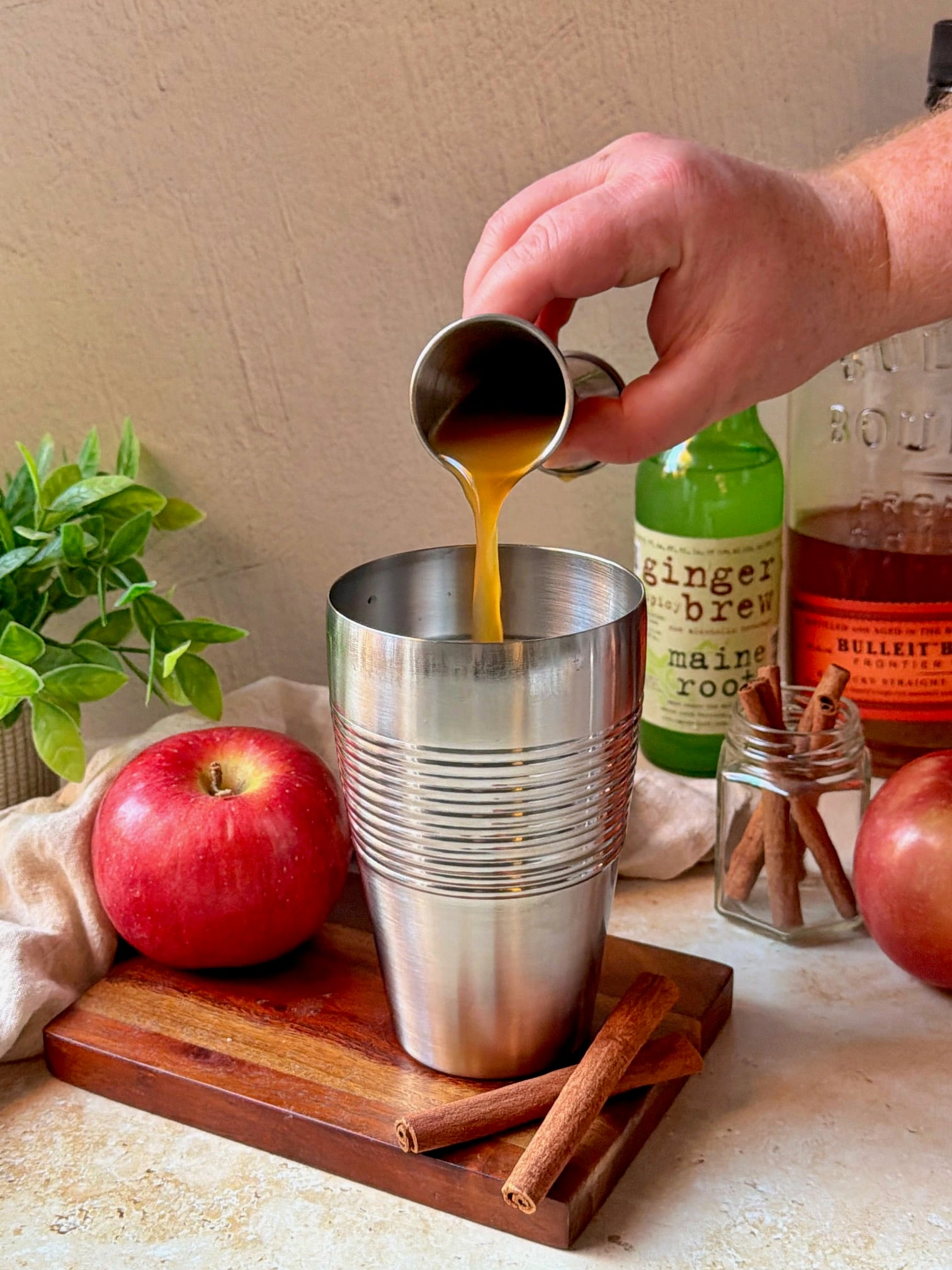 Pouring apple cider into the glass.
